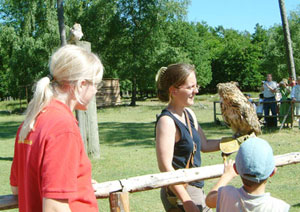 Frau mit grossem Vogel auf der  Hand und Kinder